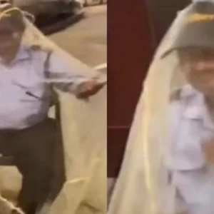 মশারিতে পুরো শরীর ঢেকে ডিউটি করছেন নিরাপত্তা প্রহরী