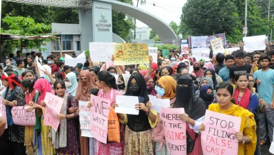 প্লাকার্ড হাতে বিক্ষোভরত শিক্ষার্থীরা । ছবি: ইত্তেফাক